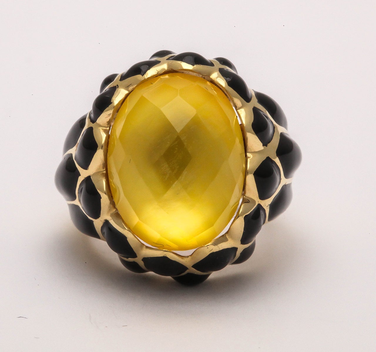 Beautiful  Multi faceted Oval citrine stone set in Black Enamel opulent Setting.  Marked 750 and bearing an Italian control mark.  Fitted with an inner tab for greater stability.